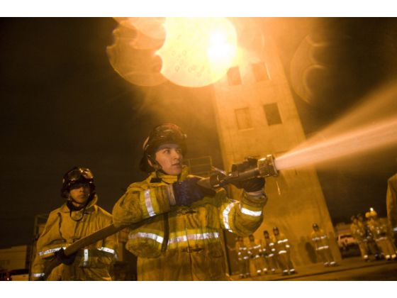 Firefighters using firehose